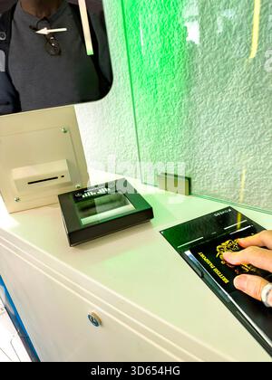 Person scanning fingerprints and passport at an automated border control checkpoint with biometric verification technology EES Stock Photo