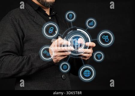 Close up to a businessman at the right side of the screen using a smart phone with a digital security concept Stock Photo