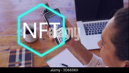 Holding smartphone, mature woman displaying QR certificate at wooden table, NFT overlay, copy space Stock Photo