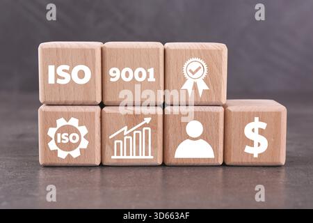 ISO 9001 Quality management systems. Wooden cubes with different icons on grey background Stock Photo