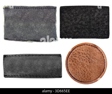 Isolated photo of worn black and brown suede and leather patches with border stitching on white background. Stock Photo