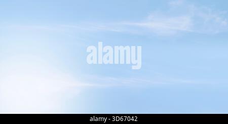 Clean soft pale blue sky with very faint almost imperceptible wisps cirrus clouds. Sky smooth gradient shifting from slightly lighter shade bottom pas Stock Photo
