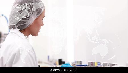 Pipetting woman in lab gear handling tubes at benchtop, with pipettor world map overlay, copy space Stock Photo