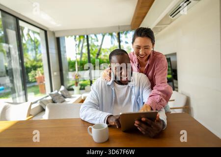 Man and woman working remotely using laptop. Male female freelancers working together. Digital nomad Stock Photo