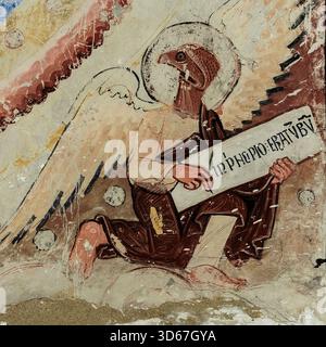 Toledo, Castilla-La Mancha, central Spain: Saint John the Evangelist, symbolically depicted as eagle holding quill pen, looks up to Christ in Majesty in Mudéjar Spanish-Moorish apse added to former Bab al-Mardum Mosque after Christian reconquest of Muslim Al-Andalus and mosque’s conversion to Cristo de la Luz or Christ of the Light church.  Romanesque 11th century CE fresco. Stock Photo