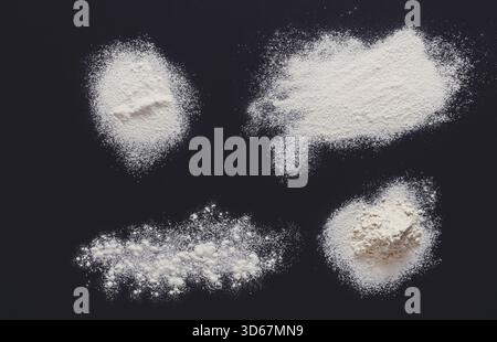 Sprinkled wheat flour splash spots on black background Stock Photo