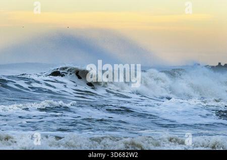 Northerly gales in winter cause large rollers or storm waves to crash onto the Yorkshire Coast causing a lot of erosion. Stock Photo