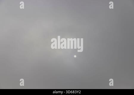 sky covered with thick clouds and thick fog that slowly dissipates from sunlight, dreary gray sky and thick fog that obscures the view Stock Photo