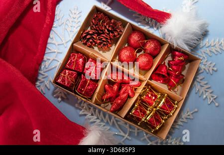 Christmas holiday background with red ornaments pine cones gift boxes and festive decorations Stock Photo