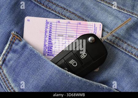 Car key and driving license in jeans pocket Stock Photo
