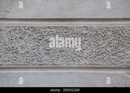 High-resolution close-up of a rough stucco plaster wall texture, granular, weathered surface details ideal for architectural, construction Stock Photo