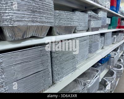 A view of several shelves dedicated to disposable aluminum foil baking trays, on display at a local grocery store. Stock Photo