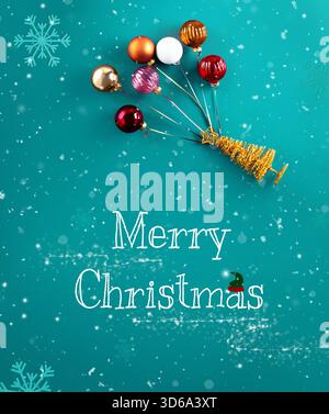 A gold miniature Christmas tree figure flying up with colorful ornaments as balloons on a teal blue background with snowflakes. High quality photo Stock Photo