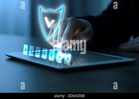 Man entering password on virtual screen above tablet computer, closeup. Cyber security and data protection concept Stock Photo