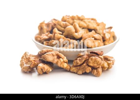 Peeled walnut kernels in bowl isolated on a white background. Stock Photo