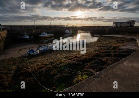 Harbour boats resting on the shore at low tide Stock Photo
