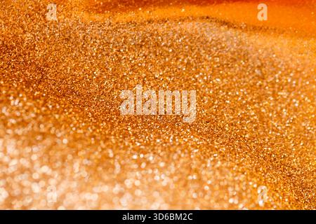 gold wallpaper.Sparkling Gold Glitter Texture. Golden relief texture.Shimmering gold texture. New Year and Christmas Wallpaper Stock Photo