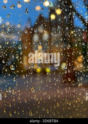 Old church seen through the raindrops on a window. Stock Photo