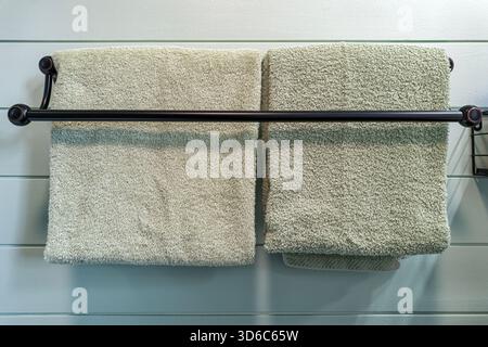 Clean towels are hanging on a rack in the bathroom Stock Photo