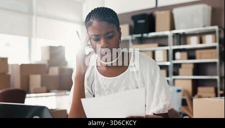 Woman, documents and stress for dropshipping, logistics or thinking with distribution mistake in office. African person, paperwork and admin with Stock Photo