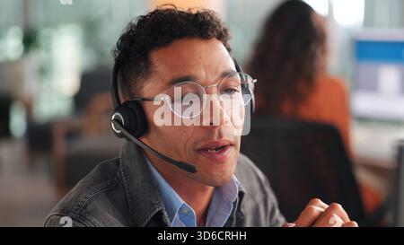 Man, headset and talk for consultation in call centre for customer service, online query and billing. Male agent, explaining and consulting for Stock Photo