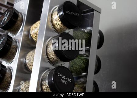 A view of a counter spice rack, seen in a home kitchen setting. Stock Photo