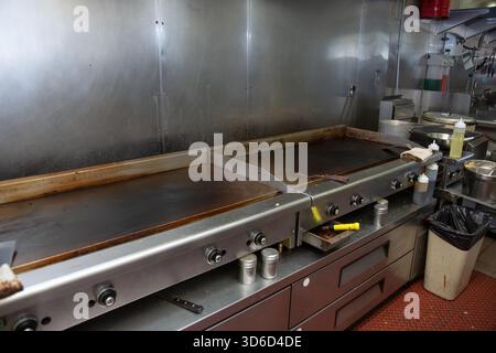 A view of a griddle appliances in a restaurant kitchen setting. Stock Photo