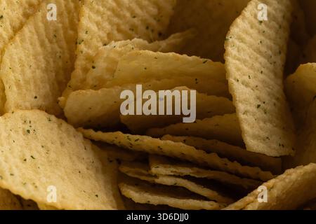 Extreme Macro Texture of Ruffled Potato Chips with Green Seasoning Stock Photo