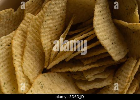 Extreme Macro Texture of Ruffled Potato Chips with Green Seasoning Stock Photo