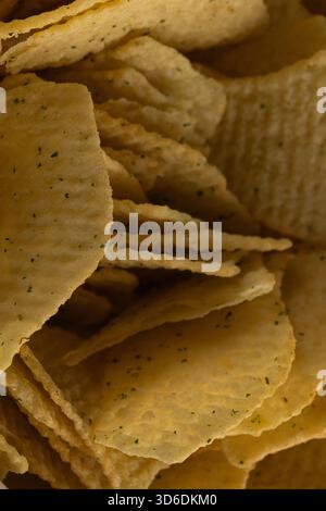 Extreme Macro Texture of Ruffled Potato Chips with Green Seasoning Stock Photo