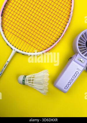 Segambut, Kuala Lumpur, Malaysia - Nov 24, 2025 : Flat lay,overhead shot.The racquet at the top left,the shuttlecock is centered and fan on the right Stock Photo