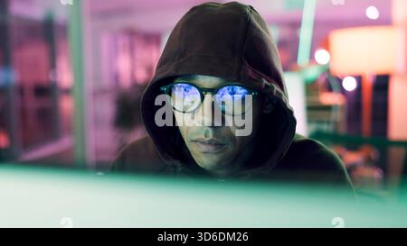 Night, hacking or man with computer for encryption breach, firewall attack or cybersecurity crisis. Confidential info, system access or it programmer Stock Photo