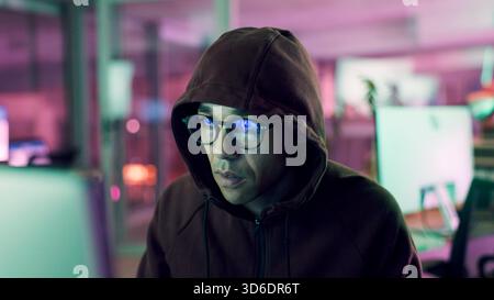 Night, hacker or man with computer for encryption breach, firewall attack or cybersecurity crisis. Confidential info, system access or programmer in Stock Photo
