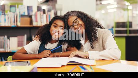 Tutor, portrait or child in library with hug, teaching or comfort in learning aid. Education, happiness and mature mentor at table with embrace Stock Photo