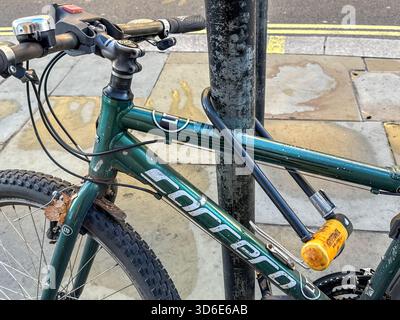 London, England, UK - 25 October 2025: Close up view of a bicycle secured to a lamp post in Regent Street in London with a heavy duty cycle lock Stock Photo