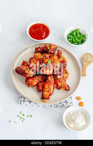 Gochujang Chicken Wings with Condiments Top Down Vertical Photo Stock Photo