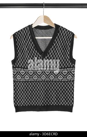 Black and white wool vest sweater hanging on clothes rack isolated over white Stock Photo
