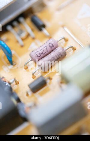A detailed macro shot of electronic components on a circuit board, showcasing resistors and connectors Ideal for illustrating TV repair or electronic Stock Photo