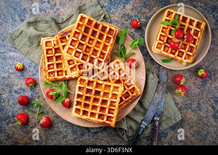 fresh baked homemade Brussels waffles with fresh strawberries on a plate Stock Photo