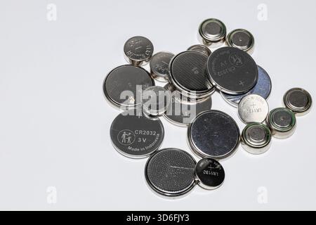 Variety of used Alkaline or lithium Battery or Button cell battery or coin cell isolated on white background. Stock Photo