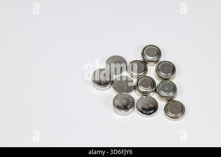 Variety of used Alkaline or lithium Battery or Button cell battery or coin cell isolated on white background. Stock Photo