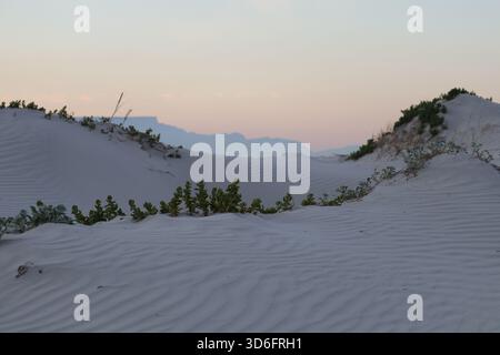 Landscape taken of the dunes of Melkbosstrand, South Africa, after a windy day with Table Mountain making a beautiful background. Stock Photo