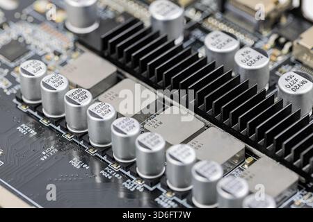 Solid-state capacitors on CPU power supply circuit of modern computer motherboard. Stock Photo