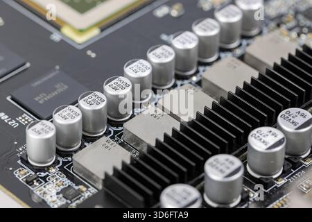 Solid-state capacitors on CPU power supply circuit of modern computer motherboard. Stock Photo