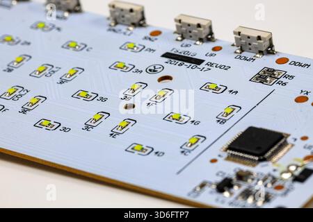 Controller module on LED light module board, electronic circuit panel with surface mount diodes on gray PCB. Stock Photo