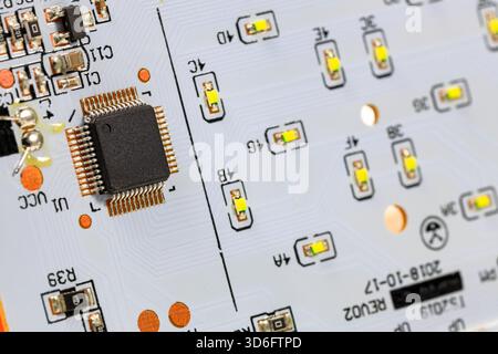 Controller module on LED light module board, electronic circuit panel with surface mount diodes on gray PCB. Stock Photo