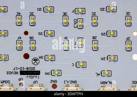 LED light module board, electronic circuit panel with surface mount diodes on gray PCB. Stock Photo