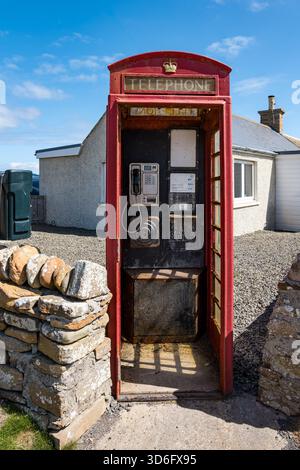 Derelict old red telephone box still in use, Birsay, Orkney Islands, Scotland, UK Stock Photo
