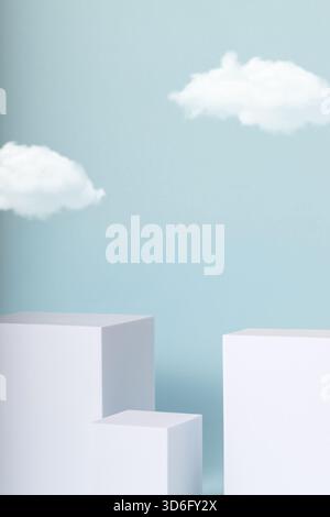 Minimal concept with white cubes and cloud on blue background. Stock Photo