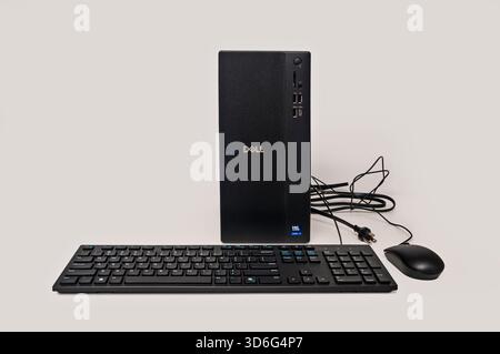 New Dell ECT1250 desktop computer tower with Intel Ultra 7 processor, along with the wired keyboard, and mouse, on a white background. Stock Photo